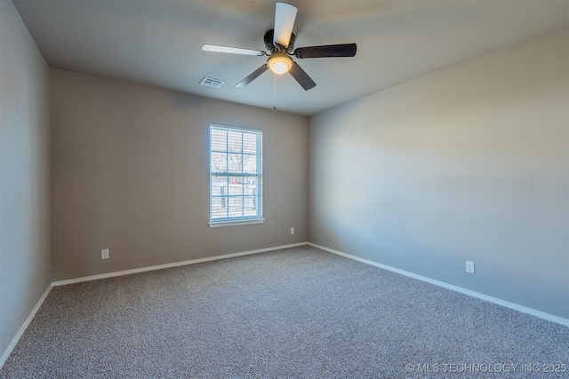 carpeted empty room featuring visible vents, baseboards, and a ceiling fan