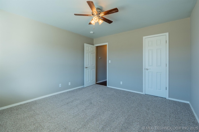 unfurnished bedroom featuring baseboards, carpet floors, and ceiling fan