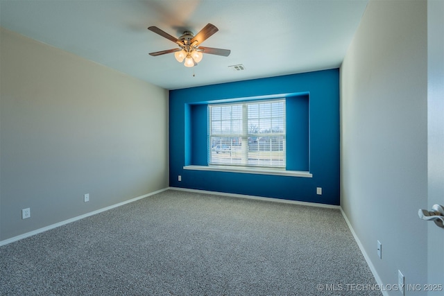 empty room featuring visible vents, ceiling fan, carpet, and baseboards