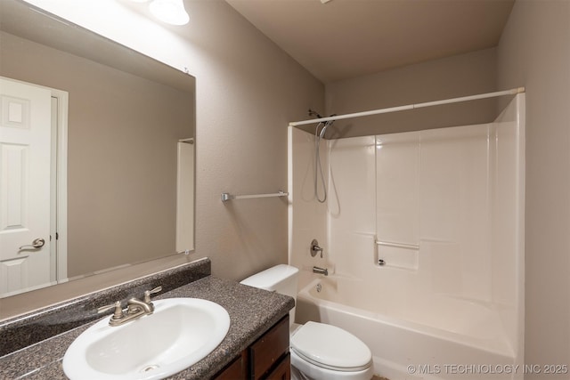 bathroom with toilet, vanity, and washtub / shower combination