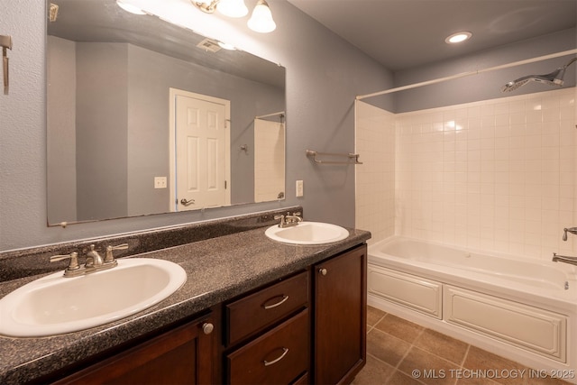 bathroom featuring a sink, bathtub / shower combination, double vanity, and tile patterned flooring