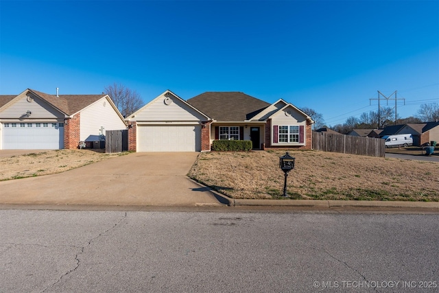 single story home featuring brick siding, an attached garage, concrete driveway, and fence