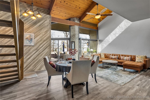 dining area featuring beam ceiling, stairway, wooden ceiling, and wood finished floors