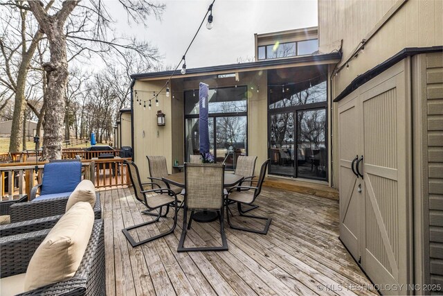 wooden terrace featuring outdoor dining area