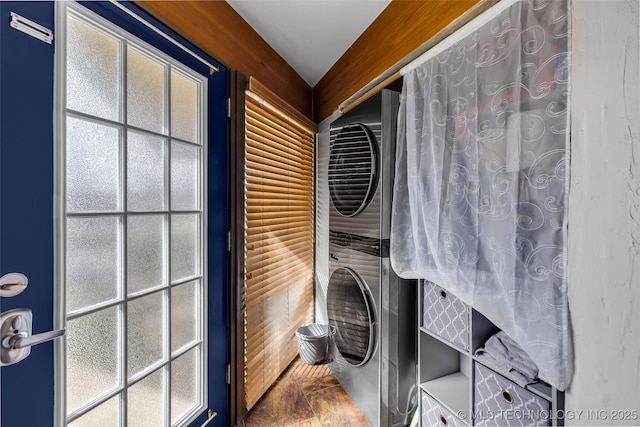 laundry room with laundry area and stacked washer / dryer