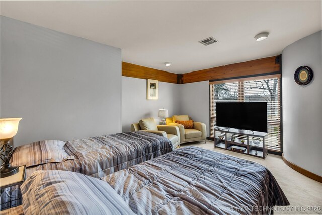 bedroom with light colored carpet, visible vents, and baseboards