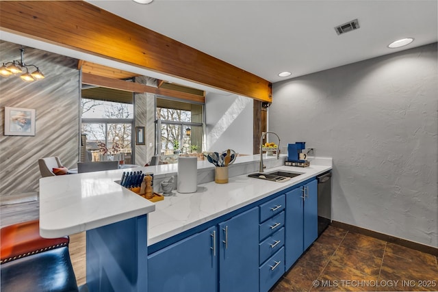 kitchen featuring dishwashing machine, visible vents, a peninsula, a sink, and blue cabinets