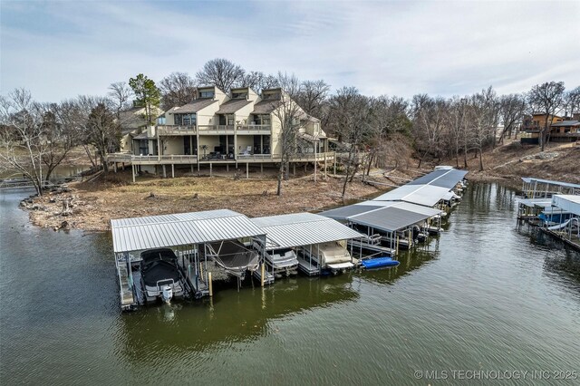 dock area with a water view and boat lift