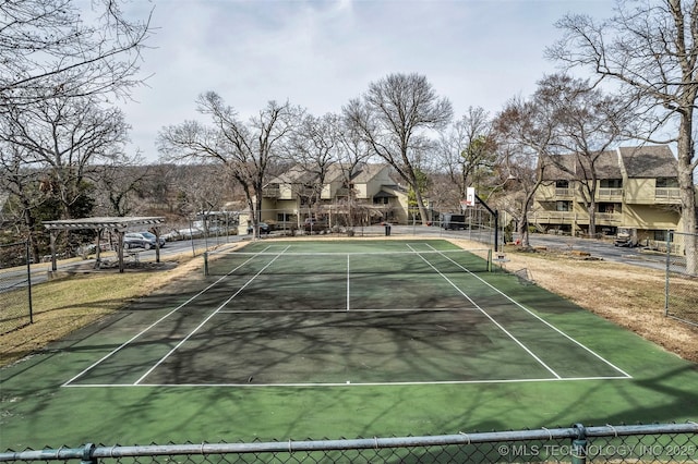 view of tennis court featuring fence