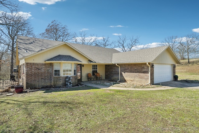 ranch-style house with brick siding, a front yard, roof with shingles, driveway, and an attached garage