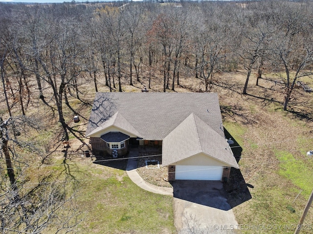 aerial view featuring a wooded view