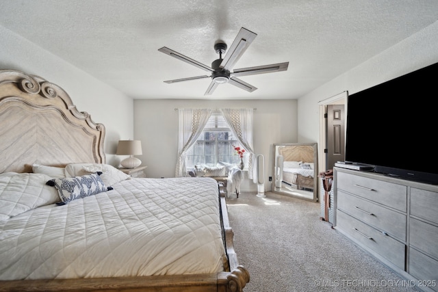 unfurnished bedroom featuring carpet flooring, a textured ceiling, and ceiling fan