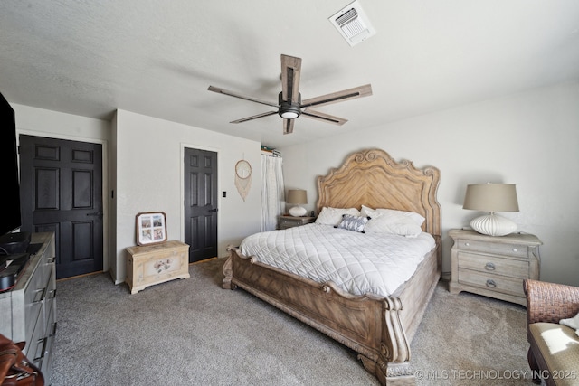 bedroom featuring visible vents, ceiling fan, and carpet floors