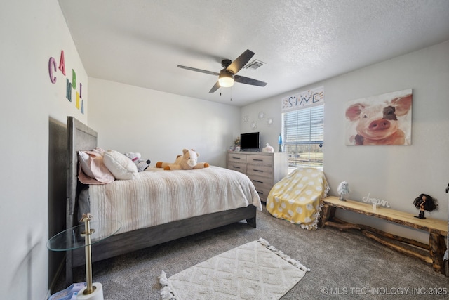 carpeted bedroom with visible vents, a textured ceiling, and ceiling fan