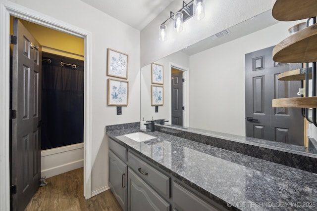 bathroom with visible vents, wood finished floors, and vanity