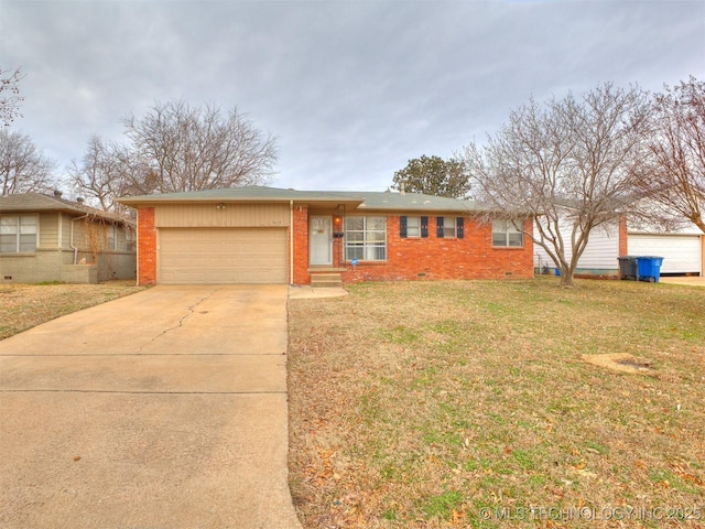 single story home featuring a garage, driveway, a front yard, crawl space, and brick siding