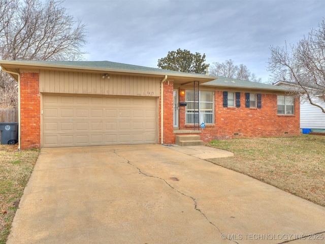 single story home with brick siding, an attached garage, a front lawn, crawl space, and driveway