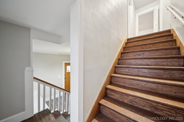 stairs featuring baseboards and wood finished floors