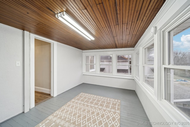 unfurnished sunroom with wood ceiling