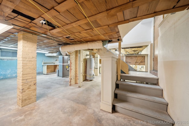 unfinished basement with stairs, heating unit, and water heater