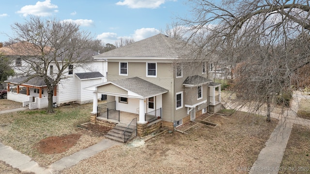 view of front of home with a porch and roof with shingles