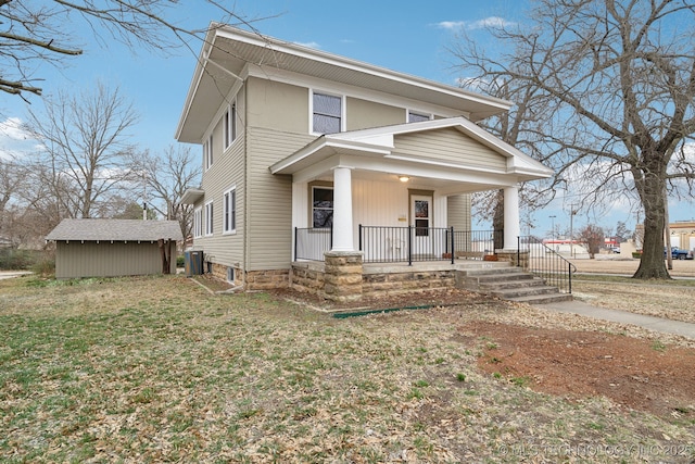 view of front of house with a storage unit, central air condition unit, an outbuilding, and a porch