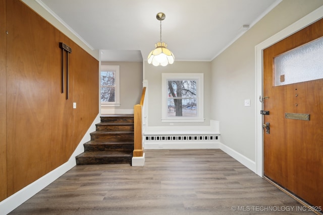 entryway featuring stairway, wood finished floors, radiator heating unit, and ornamental molding