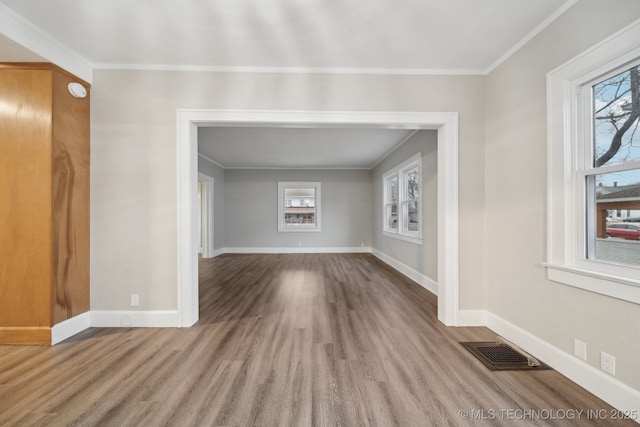 unfurnished room with plenty of natural light, baseboards, and visible vents