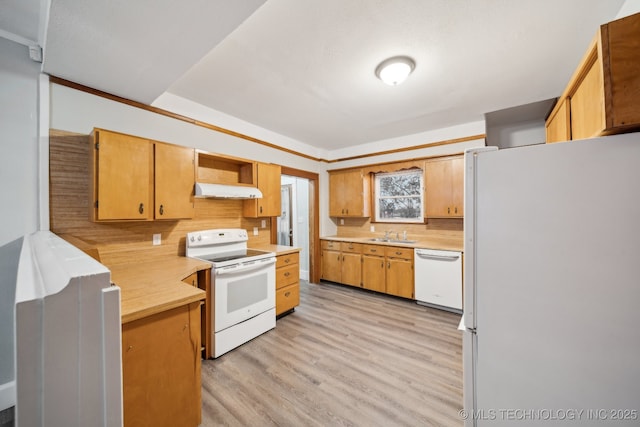 kitchen with light wood-type flooring, under cabinet range hood, backsplash, white appliances, and light countertops