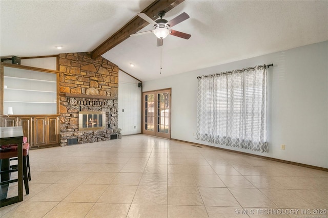 unfurnished living room featuring lofted ceiling with beams, a stone fireplace, french doors, a textured ceiling, and tile patterned floors