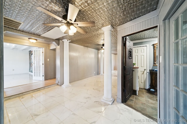 interior space featuring decorative columns, marble finish floor, visible vents, and an ornate ceiling