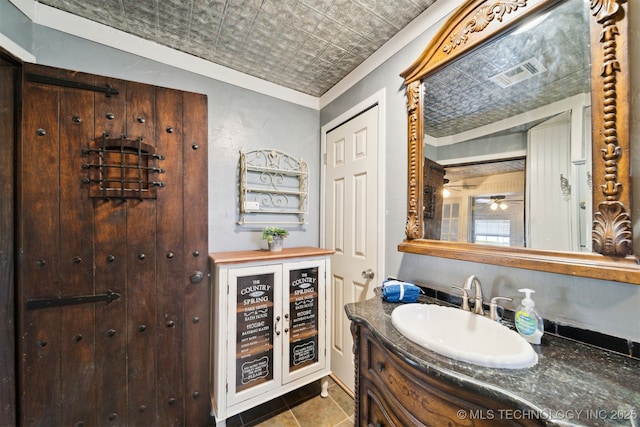 bathroom featuring tile patterned floors, visible vents, an ornate ceiling, and vanity