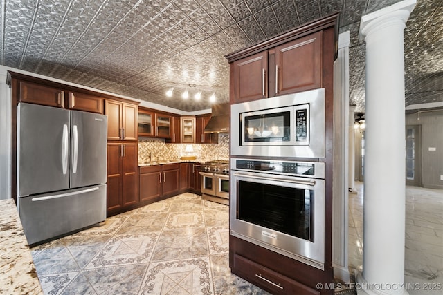 kitchen with backsplash, glass insert cabinets, light stone countertops, an ornate ceiling, and stainless steel appliances