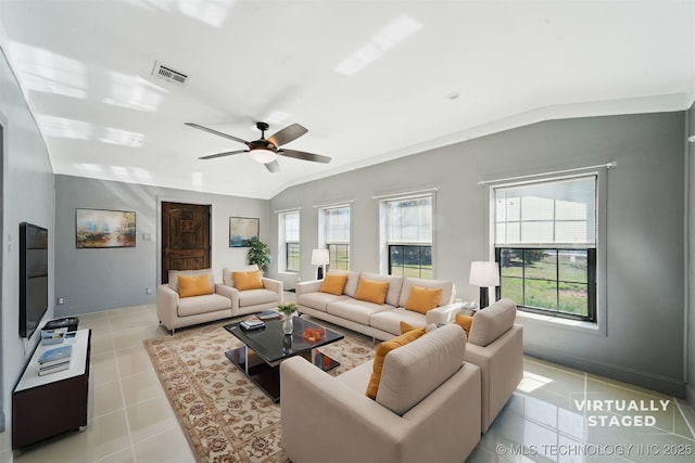 living area featuring light tile patterned flooring, visible vents, a wealth of natural light, and vaulted ceiling