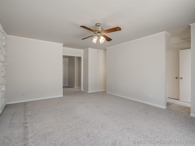 spare room with light colored carpet, baseboards, ceiling fan, and ornamental molding