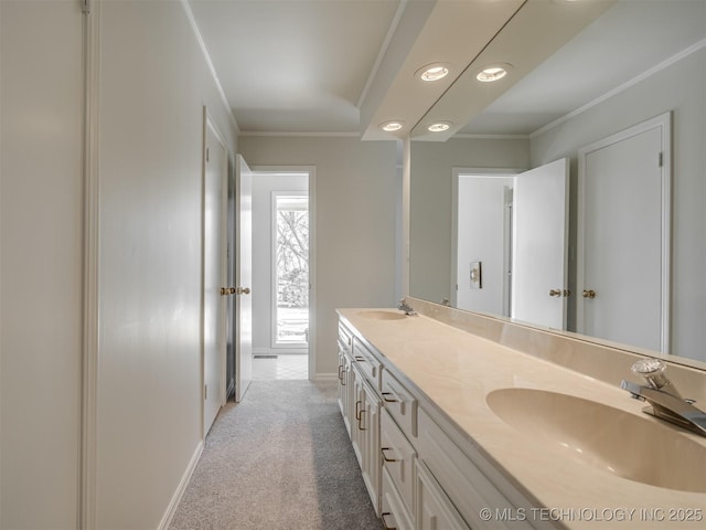 bathroom with a sink, double vanity, and crown molding