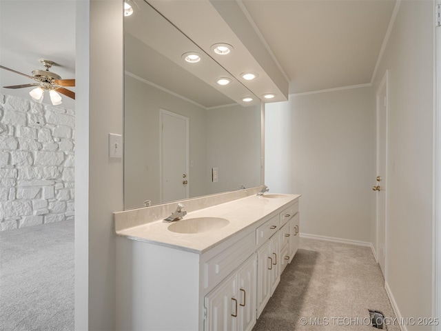 bathroom with ceiling fan, double vanity, ornamental molding, and a sink