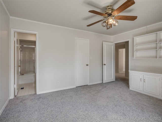 unfurnished bedroom featuring baseboards, carpet, ensuite bath, and ornamental molding