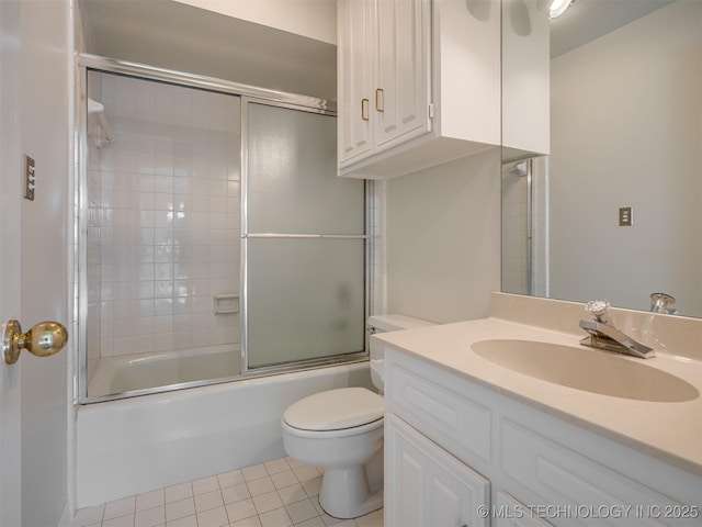 full bathroom featuring tile patterned flooring, toilet, vanity, and bath / shower combo with glass door