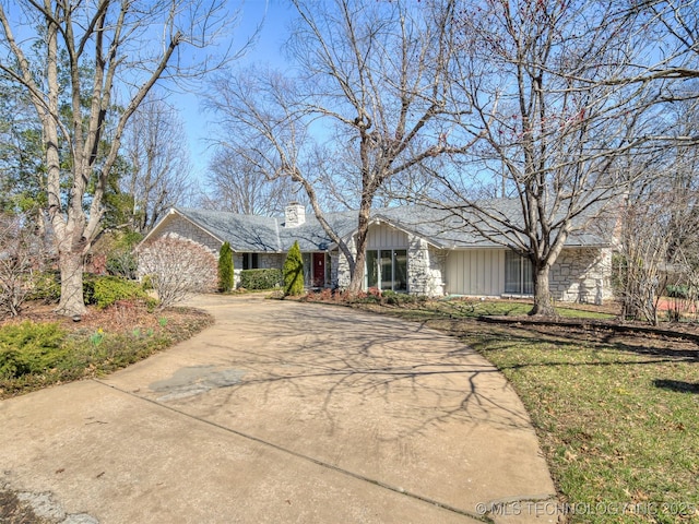 view of front of house with board and batten siding and driveway