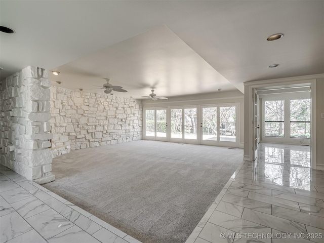 unfurnished living room with plenty of natural light and marble finish floor