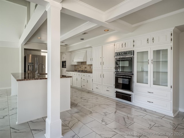 kitchen with crown molding, custom range hood, appliances with stainless steel finishes, marble finish floor, and a warming drawer