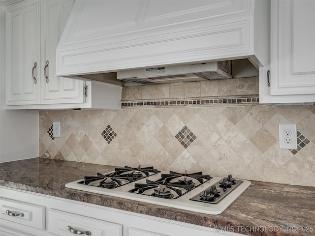 kitchen featuring white gas cooktop, custom exhaust hood, white cabinets, dark countertops, and backsplash