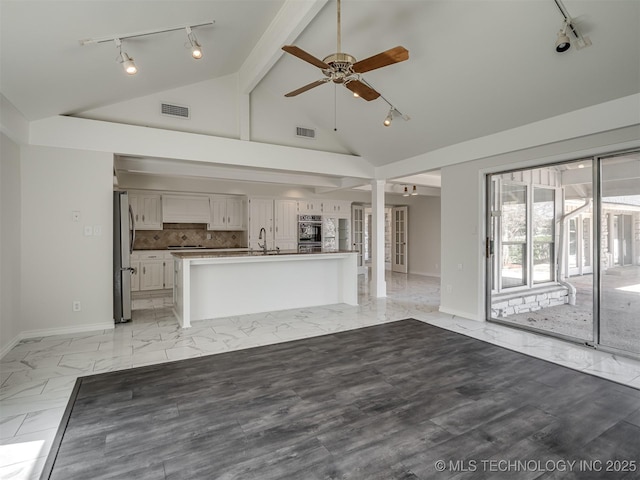 unfurnished living room with visible vents, baseboards, marble finish floor, and ceiling fan