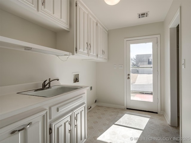 clothes washing area featuring visible vents, washer hookup, a sink, cabinet space, and hookup for an electric dryer