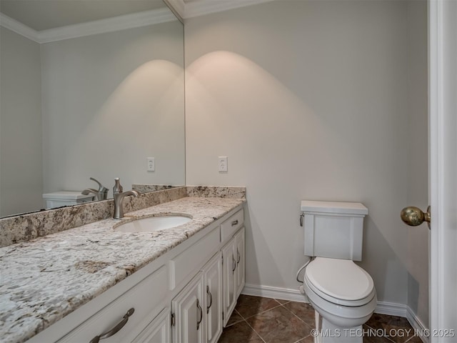 bathroom featuring vanity, baseboards, ornamental molding, tile patterned flooring, and toilet