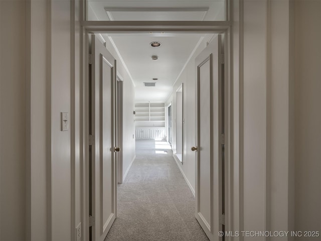 corridor featuring carpet flooring and visible vents