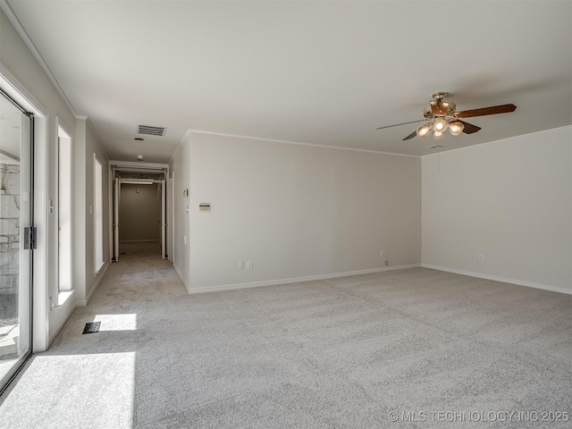 spare room featuring visible vents, baseboards, light carpet, and a ceiling fan