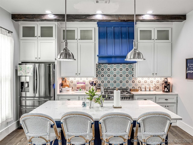 kitchen with dark wood finished floors, white cabinets, stainless steel refrigerator with ice dispenser, beamed ceiling, and backsplash