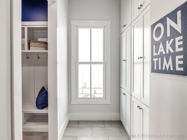 mudroom featuring light tile patterned floors and baseboards